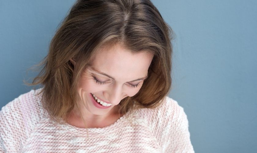 Menopausia afecta a la salud oral: mujer sonriendo.